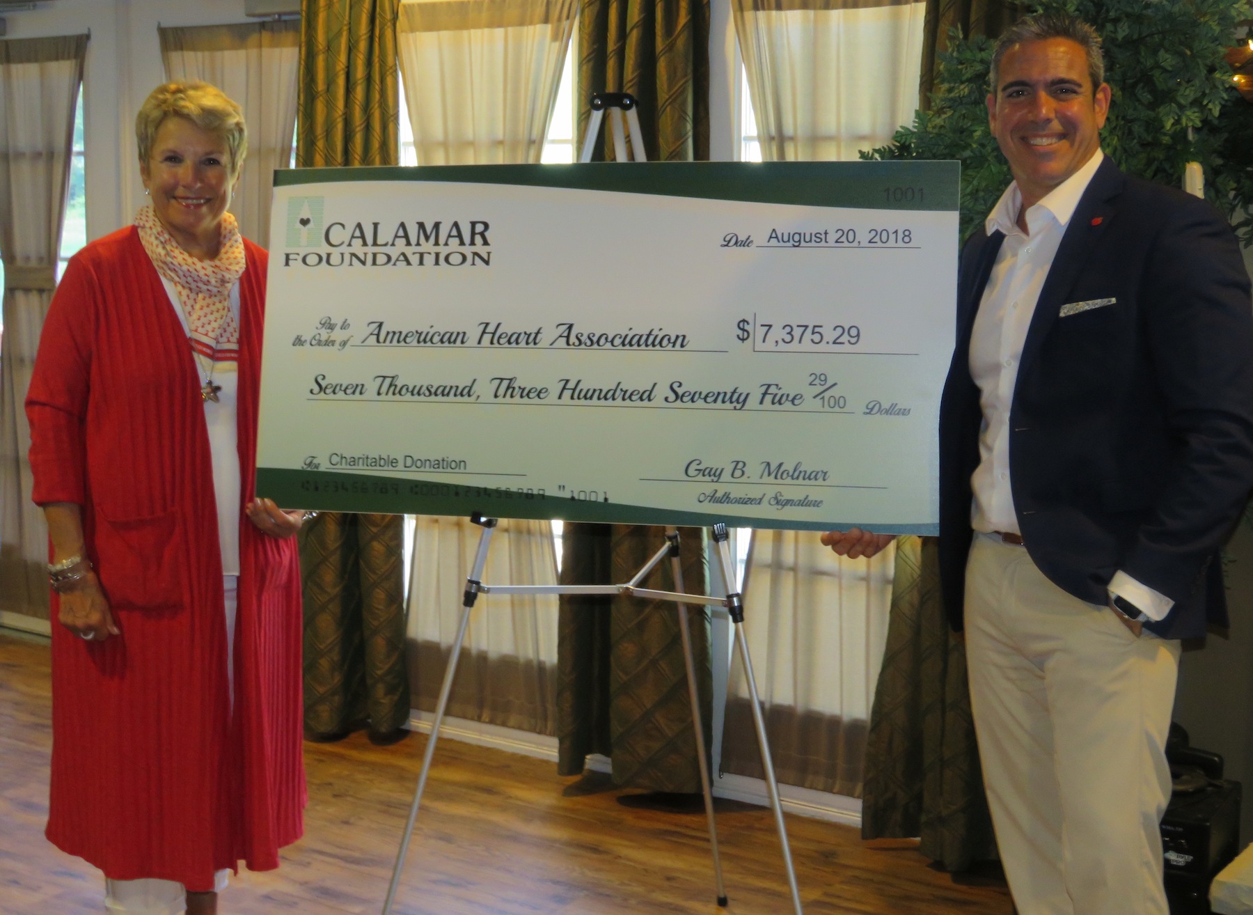 From left, Calamar Foundation President Gay Molnar and American Heart Association Executive Director Marc Natale pose for a photo next to the $7,375.29 check, which was presented at Forestview Active Living. (All photos by David Yarger)